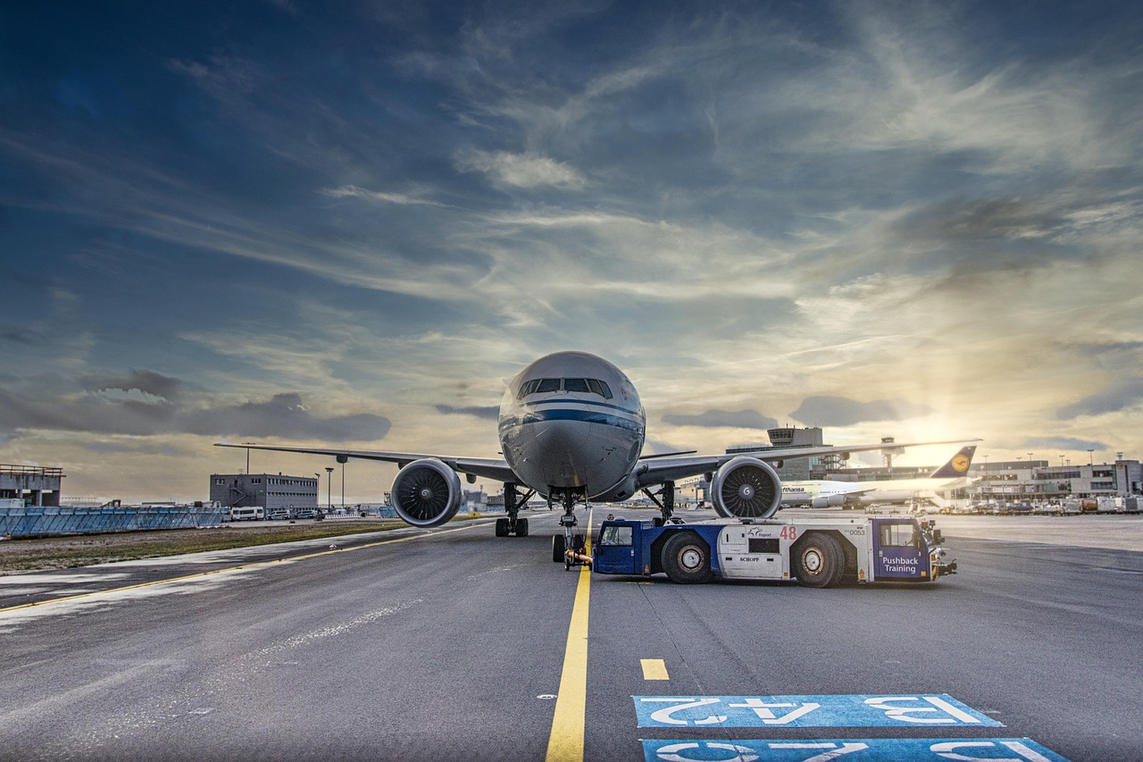 airplane, runway, airport, tarmac, nature, aircraft, vehicle, truck, airliner, clouds, asphalt, jet, flight, transportation system, air travel, outdoor, airline, plane, transportation, travel, airfield
